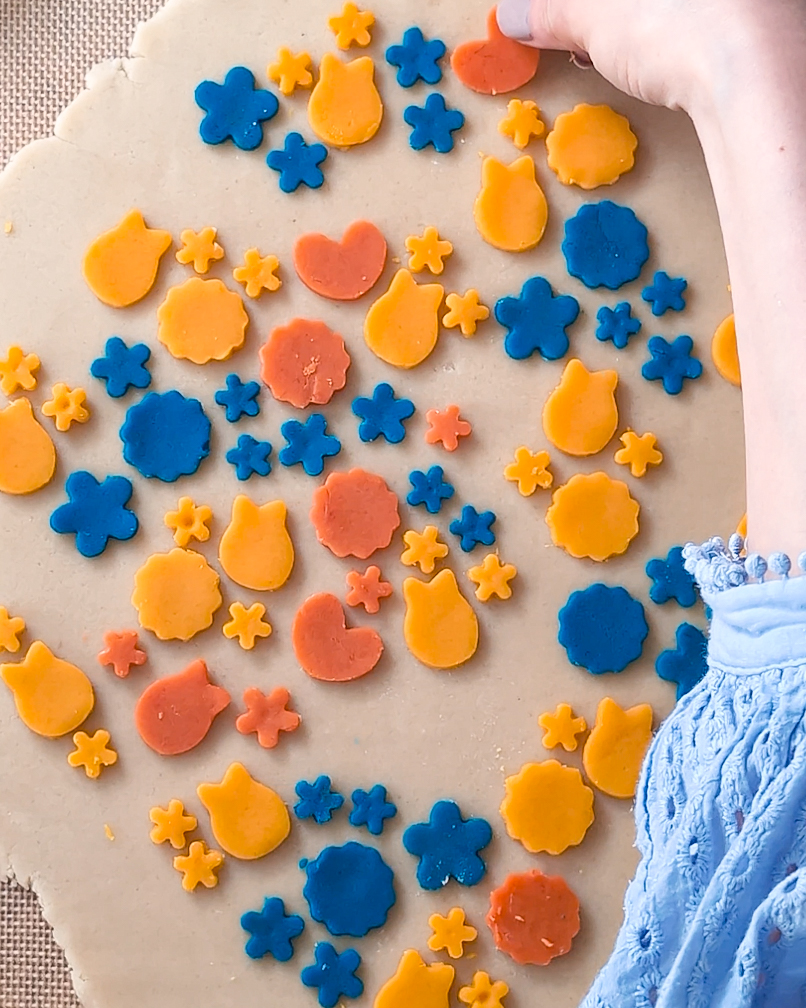 Arranging pattern on colourful Bunny Butter Cookie with yellow, orange, and blue.